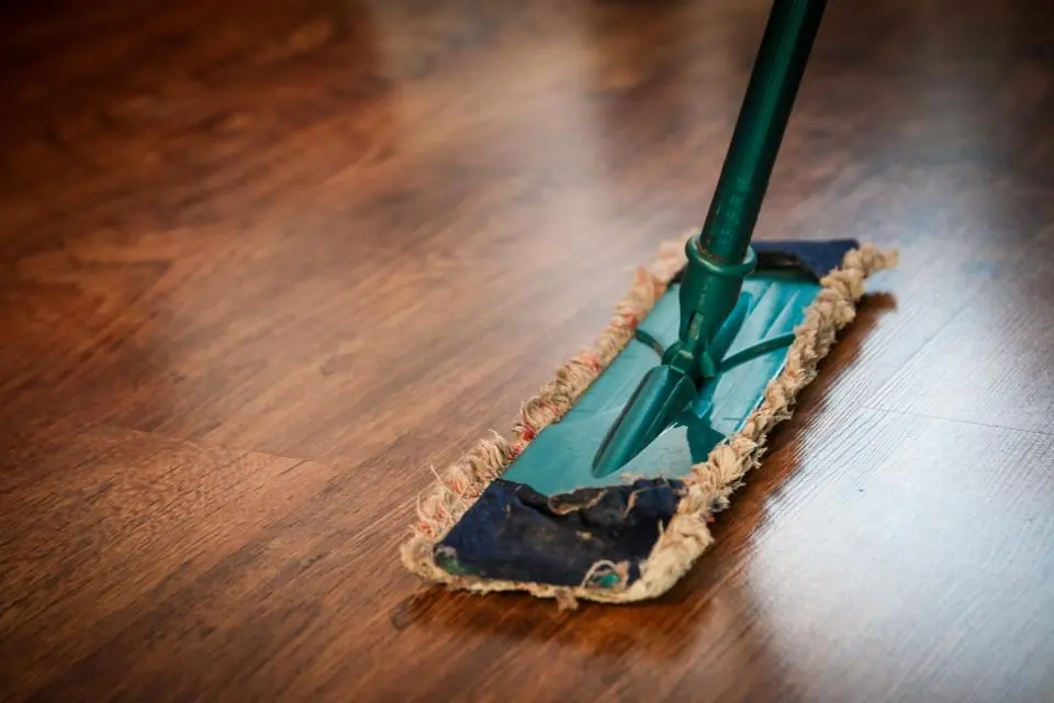 A flat mop cleaning a polished hardwood floor
